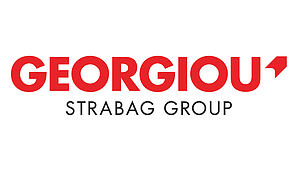 Logo of Georgiou Group, a STRABAG Group company. The logo features the word “GEORGIOU” in bold red uppercase letters above the text “STRABAG GROUP” in black uppercase letters, displayed on a white background with a red graphic element incorporated into the company name.